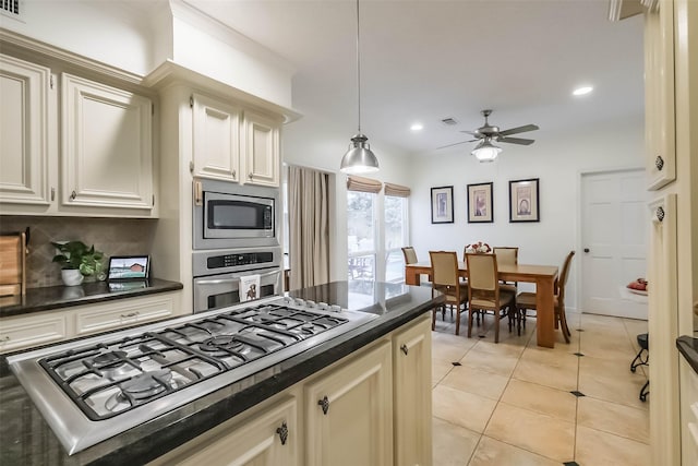 602 Rock Cv, Houston, TX 77079 - kitchen with stainless steel appliances, dark countertops, backsplash, a ceiling fan, and recessed lighting