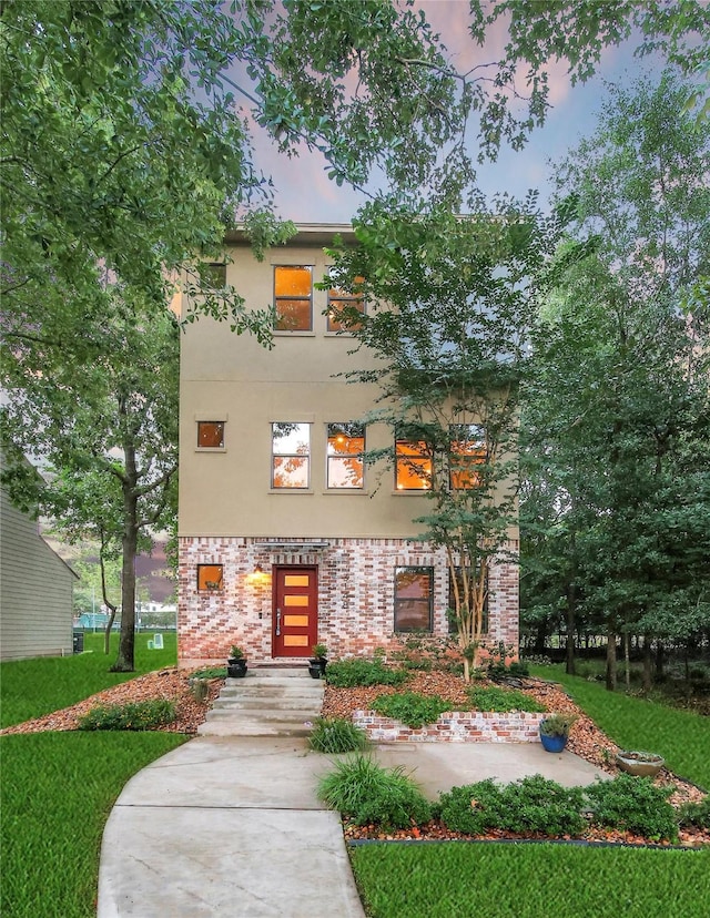 3148 Poe Dr, Montgomery, TX 77356 - view of front of property with stucco siding, brick siding, and a front lawn
