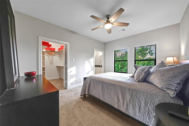 3148 Poe Dr, Montgomery, TX 77356 - bedroom with light colored carpet, a walk in closet, baseboards, a ceiling fan, and a closet