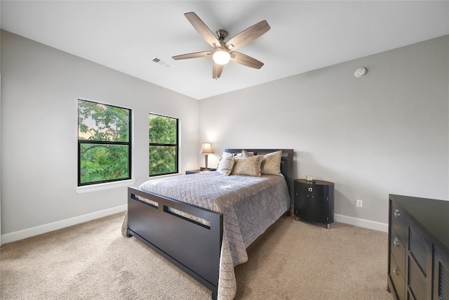 3148 Poe Dr, Montgomery, TX 77356 - bedroom with baseboards, light carpet, and a ceiling fan