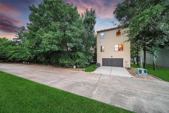 3148 Poe Dr, Montgomery, TX 77356 - view of front facade featuring a garage, concrete driveway, a lawn, and cooling unit