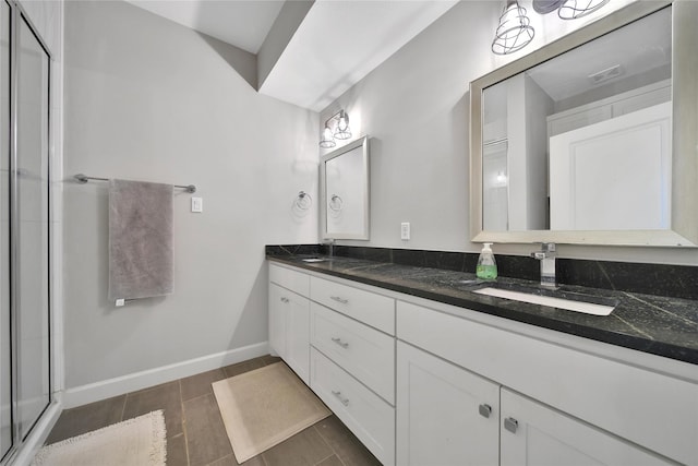 3148 Poe Dr, Montgomery, TX 77356 - bathroom with double vanity, a stall shower, and baseboards