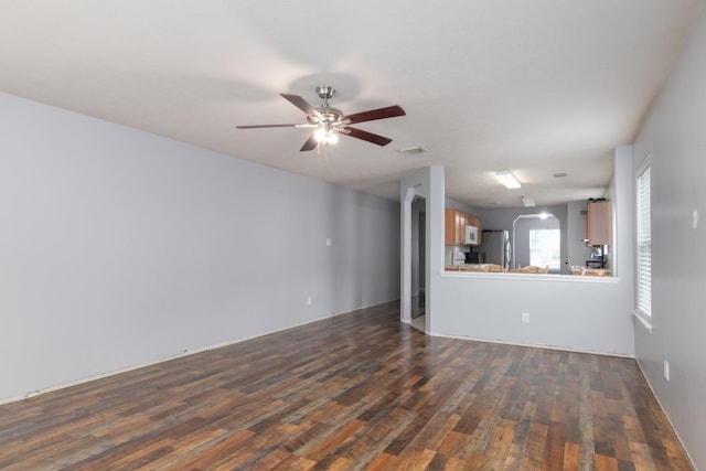 24027 Pinecreek Pt, Spring, TX 77373 - unfurnished living room featuring dark wood-type flooring and a ceiling fan