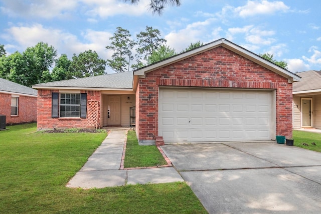 24027 Pinecreek Pt, Spring, TX 77373 - ranch-style home featuring brick siding, an attached garage, concrete driveway, a front yard, and central air condition unit