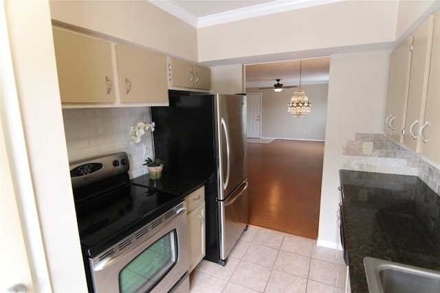 9003 Gaylord Dr Unit 11, Houston, TX 77024 - kitchen featuring stainless steel appliances, cream cabinetry, ornamental molding, tasteful backsplash, and dark countertops