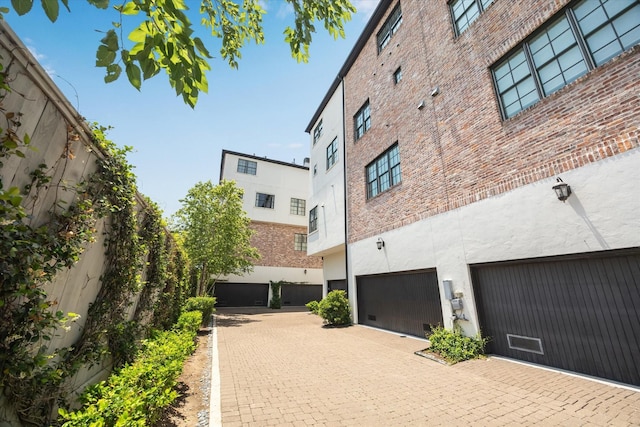 3850 Glen Arbor Dr, Houston, TX 77025 - view of building exterior featuring driveway and an attached garage