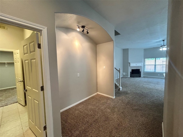 3123 Candle Cabin Ln, Spring, TX 77388 - corridor with light colored carpet, baseboards, stairs, light tile patterned floors, and arched walkways