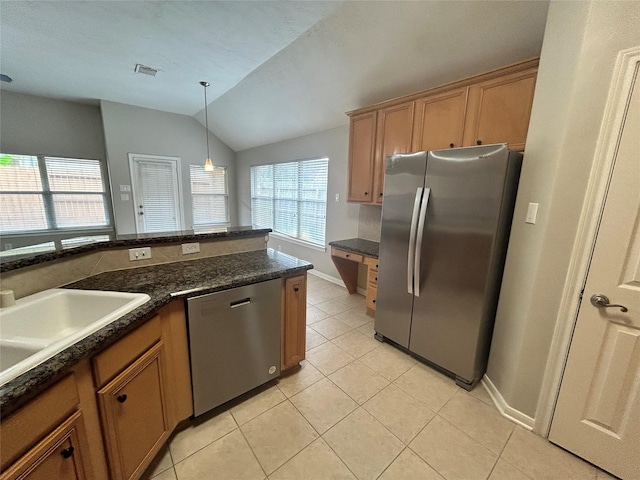 3123 Candle Cabin Ln, Spring, TX 77388 - kitchen featuring appliances with stainless steel finishes, light tile patterned floors, lofted ceiling, brown cabinets, and pendant lighting