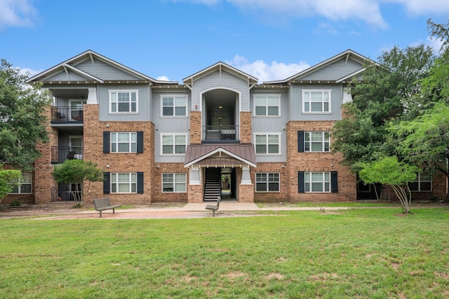 1725 Harvey Mitchell Pkwy S Unit 2433, College Station, TX 77840 - view of front facade featuring a front yard and brick siding