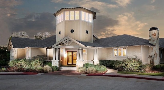 1725 Harvey Mitchell Pkwy S Unit 2433, College Station, TX 77840 - view of front facade featuring french doors and a chimney