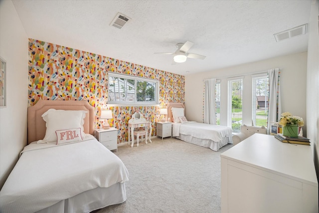 2714 Fontana Dr, Houston, TX 77043 - bedroom featuring wallpapered walls, carpet flooring, a textured ceiling, and ceiling fan