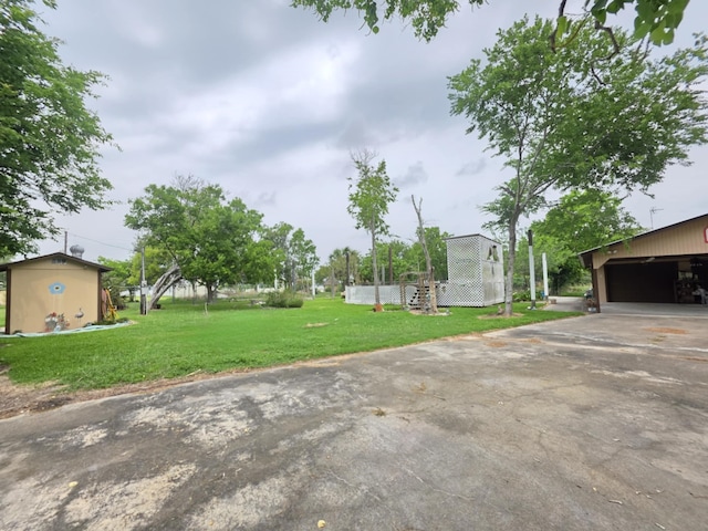 182 Smith Rd, Palacios, TX 77465 - view of grassy yard featuring concrete driveway