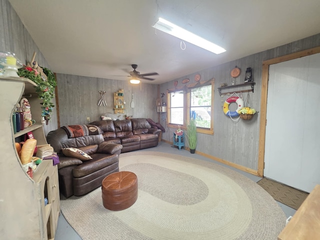 182 Smith Rd, Palacios, TX 77465 - living room featuring ceiling fan and wood walls