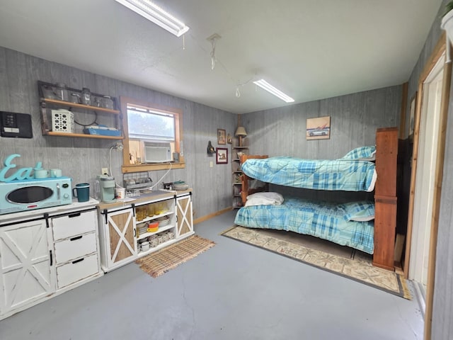 182 Smith Rd, Palacios, TX 77465 - bedroom featuring cooling unit, finished concrete floors, and a ceiling fan