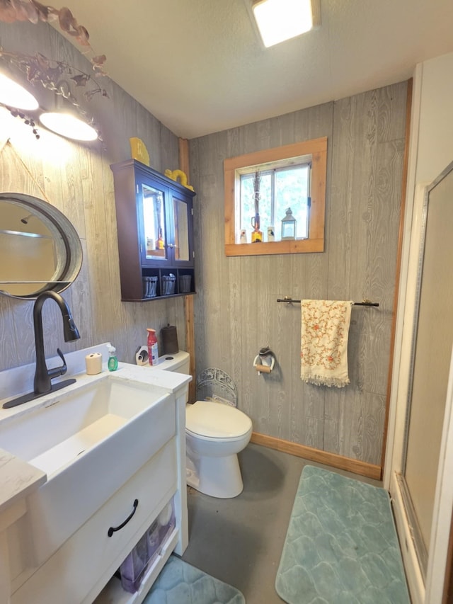182 Smith Rd, Palacios, TX 77465 - bathroom featuring toilet, vanity, finished concrete flooring, and a shower stall