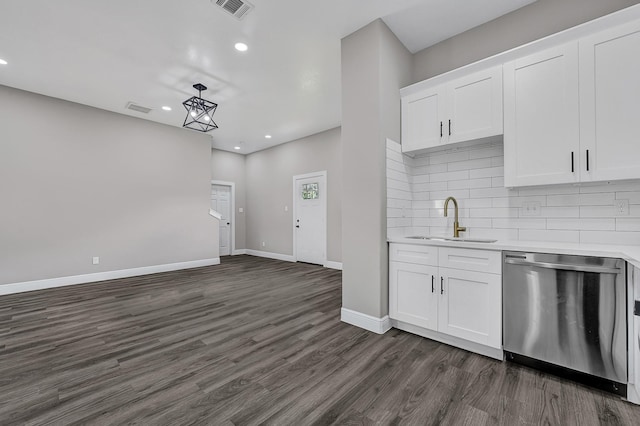9805 Fabiola Dr, Houston, TX 77075 - kitchen with dishwasher, a sink, dark wood-type flooring, recessed lighting, and light countertops