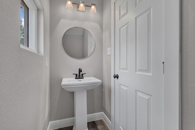 9805 Fabiola Dr, Houston, TX 77075 - bathroom with wood finished floors, baseboards, and a sink