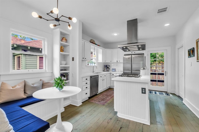 1618 Lawrence St, Houston, TX 77008 - kitchen with island exhaust hood, stainless steel appliances, healthy amount of natural light, light countertops, and recessed lighting