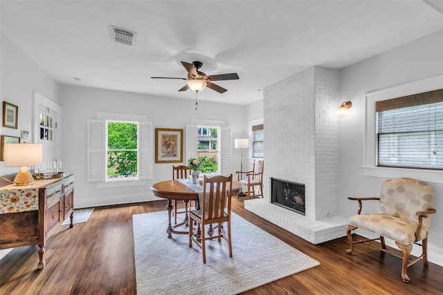 1618 Lawrence St, Houston, TX 77008 - dining area with a ceiling fan, wood finished floors, baseboards, and a fireplace