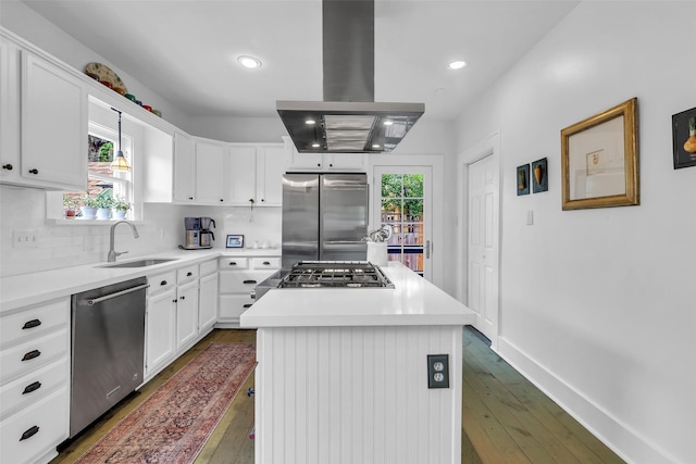 1618 Lawrence St, Houston, TX 77008 - kitchen featuring island range hood, stainless steel appliances, dark wood finished floors, a sink, and tasteful backsplash