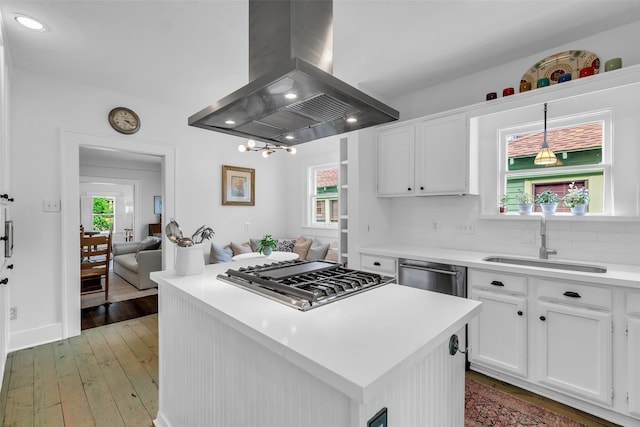 1618 Lawrence St, Houston, TX 77008 - kitchen with island exhaust hood, a sink, stainless steel appliances, white cabinets, and light countertops