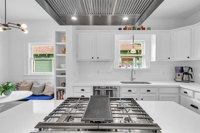 1618 Lawrence St, Houston, TX 77008 - kitchen with a sink, wall chimney range hood, white cabinets, light countertops, and stainless steel appliances