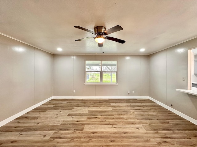 7845 Bonaire St, Houston, TX 77028 - unfurnished room featuring wood finished floors, ceiling fan, crown molding, recessed lighting, and baseboards