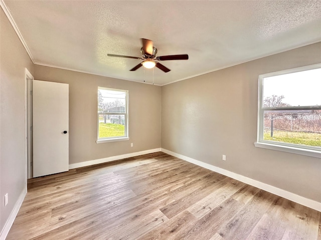 7845 Bonaire St, Houston, TX 77028 - empty room with ceiling fan, wood finished floors, baseboards, crown molding, and a textured ceiling