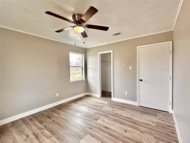 7845 Bonaire St, Houston, TX 77028 - unfurnished bedroom with ornamental molding, light wood finished floors, baseboards, and a ceiling fan