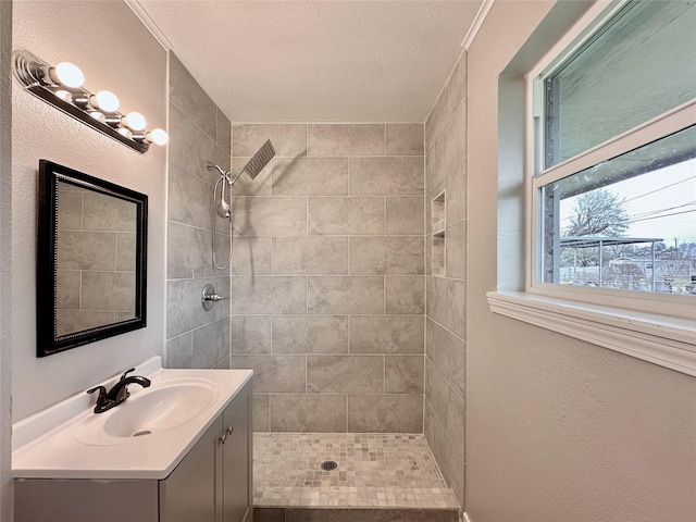 7845 Bonaire St, Houston, TX 77028 - bathroom with a tile shower, vanity, a textured ceiling, and a textured wall