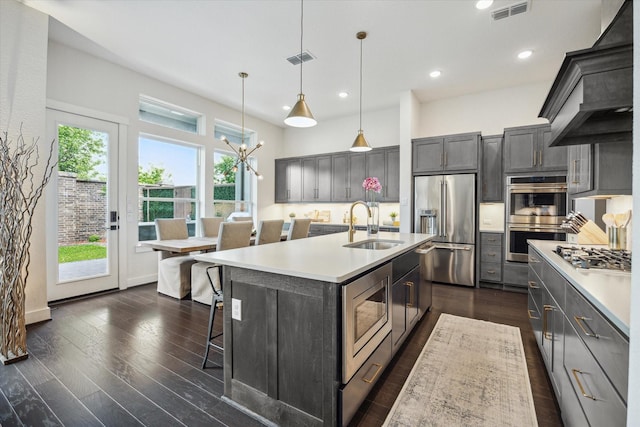 3116 Somerset Levens Ln, Houston, TX 77055 - kitchen featuring appliances with stainless steel finishes, premium range hood, a sink, light countertops, and recessed lighting