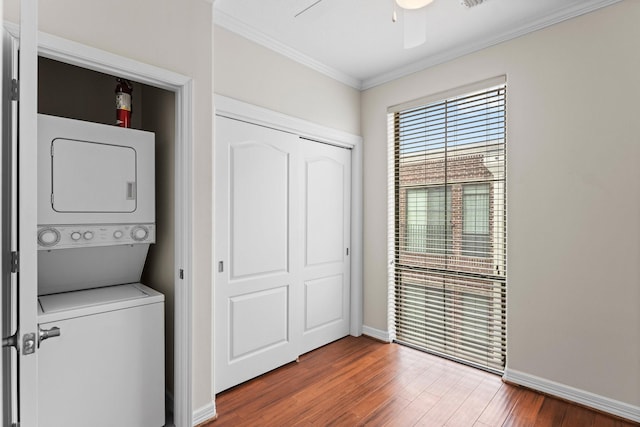 118 Mcgowen St Unit E, Houston, TX 77006 - washroom featuring stacked washer / drying machine, ornamental molding, wood finished floors, ceiling fan, and baseboards