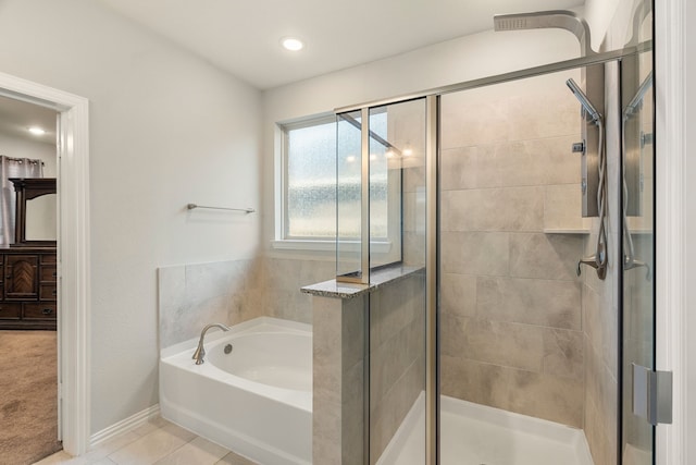 8219 Delta Down Dr, Fulshear, TX 77441 - full bathroom featuring a bath, a shower stall, and tile patterned floors