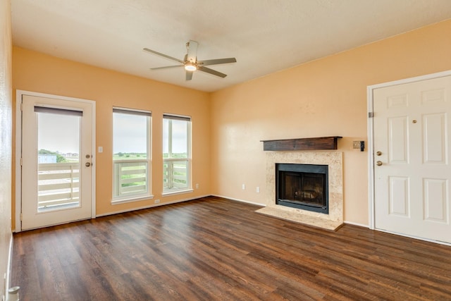 500 Ferry Rd Unit 434D, Galveston, TX 77550 - unfurnished living room with ceiling fan, dark wood-type flooring, and a fireplace with flush hearth