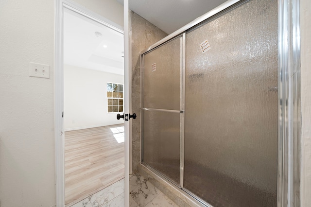 305 E Humble St, Baytown, TX 77520 - bathroom featuring marble look tiles and a shower with shower door