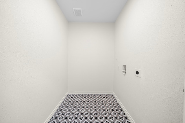 305 E Humble St, Baytown, TX 77520 - laundry area featuring electric dryer hookup, baseboards, tile patterned floors, and hookup for a washing machine