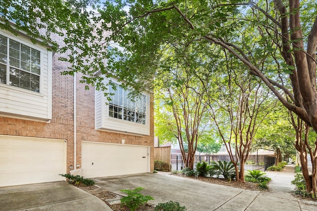 1202 Marconi St, Houston, TX 77019 - view of front of house featuring concrete driveway, a garage, and brick siding