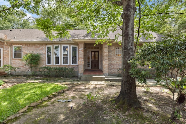 127 S Copperknoll Cir, The Woodlands, TX 77381 - view of front facade featuring brick siding and a shingled roof