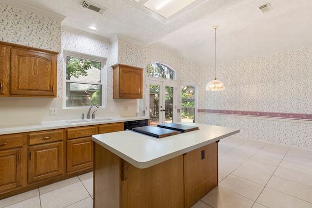 127 S Copperknoll Cir, The Woodlands, TX 77381 - kitchen featuring wallpapered walls, a sink, french doors, and brown cabinetry