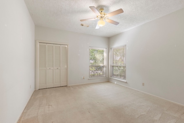 127 S Copperknoll Cir, The Woodlands, TX 77381 - unfurnished bedroom featuring carpet floors, a textured ceiling, ceiling fan, a closet, and baseboards
