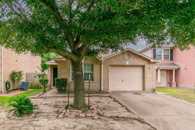 12518 Rosslare Dr, Houston, TX 77066 - view of front facade with concrete driveway, a garage, and brick siding