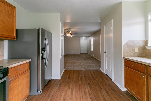 12518 Rosslare Dr, Houston, TX 77066 - kitchen with ceiling fan, dark wood-style flooring, brown cabinets, and light countertops