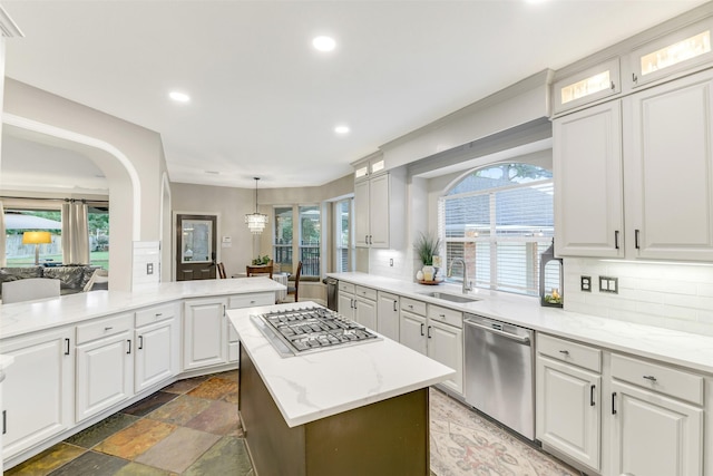 15912 Rosethorn Ct, Cypress, TX 77429 - kitchen with stainless steel appliances, a kitchen island, backsplash, recessed lighting, and white cabinets
