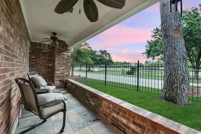 15912 Rosethorn Ct, Cypress, TX 77429 - patio terrace at dusk featuring ceiling fan, a water view, and a patio