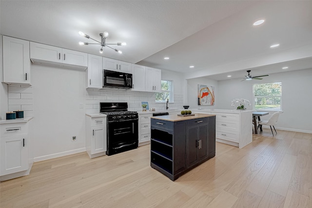 2414 Walnut Bend Ln, Houston, TX 77042 - kitchen with black appliances, light countertops, white cabinets, decorative backsplash, and recessed lighting