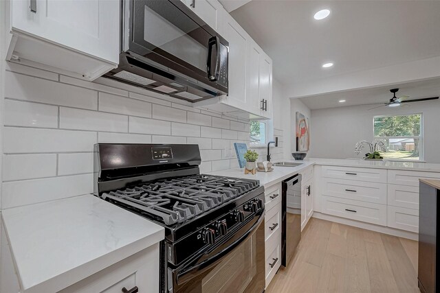 2414 Walnut Bend Ln, Houston, TX 77042 - kitchen featuring black appliances, a sink, light countertops, backsplash, and white cabinets