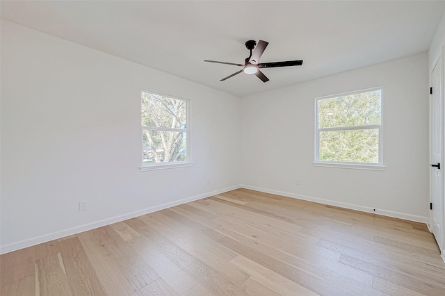 2414 Walnut Bend Ln, Houston, TX 77042 - spare room featuring plenty of natural light, ceiling fan, light wood-type flooring, and baseboards