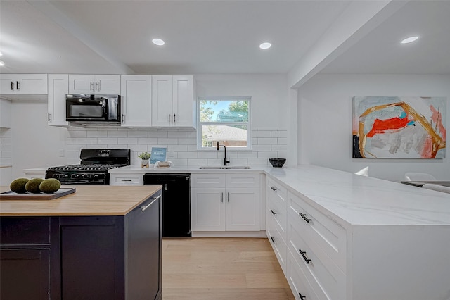 2414 Walnut Bend Ln, Houston, TX 77042 - kitchen featuring black appliances, a sink, backsplash, white cabinets, and recessed lighting