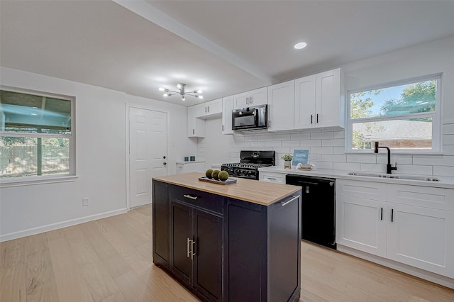 2414 Walnut Bend Ln, Houston, TX 77042 - kitchen featuring black appliances, a sink, decorative backsplash, and plenty of natural light