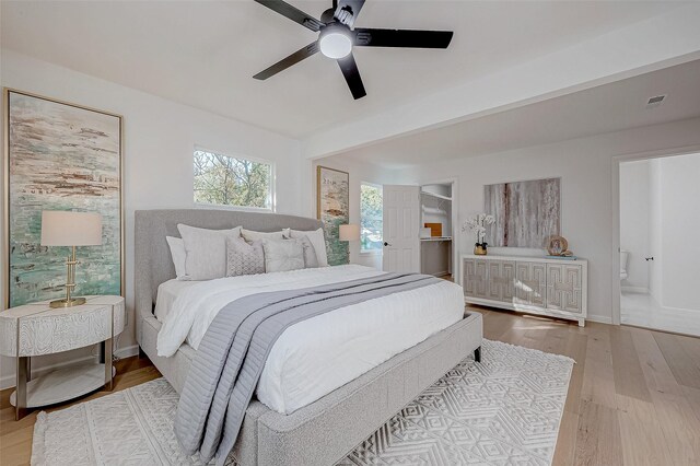 2414 Walnut Bend Ln, Houston, TX 77042 - bedroom with wood finished floors, ensuite bath, a ceiling fan, and baseboards